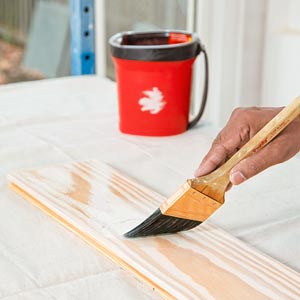 painter Mauro Henrique wipes applies finish in the TOH TV Cambridge house