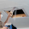 Cutting out attic access opening with a drywall handsaw