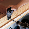 Install cable pulleys to enable pulley system to slide stairs down when attic door is opened
