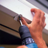 3. Fasten two metal mounting clips to the head casing over the doorway. Use one screw per clip.