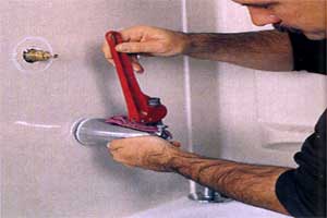 removing the tub spout with a pipe wrench