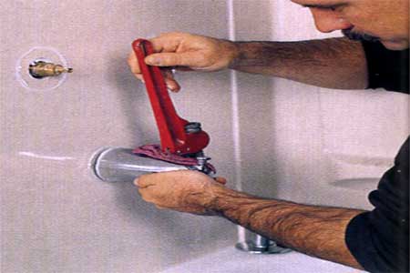 removing the tub spout with a pipe wrench