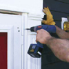 Set the door into the opening and drive screws through the mounting flange and into the existing wood brick mold