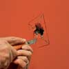 cutting an X in the drywall hole