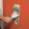 covering seams of drywall patch with joint compound