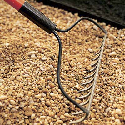 Filling the path with gravel.