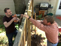 roger cook and homeowner putting up a fence