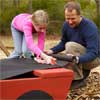 line the inside of the sandbox with fabric