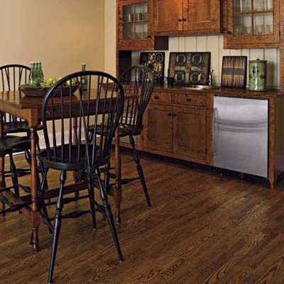 kitchen/dining area in a basement remodel with engineered wood flooring