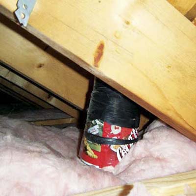 2-liter Coke bottle used as part of the water heater flue pipe