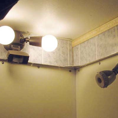 exterior flood lights installed inside the interior of an indoor shower stall