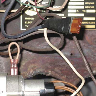 car fuse wired into the internal wiring of an indoor furnace