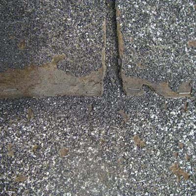 old shingles stapled down to the roof with office staples