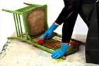 someone scraping old paint from a vintage chair