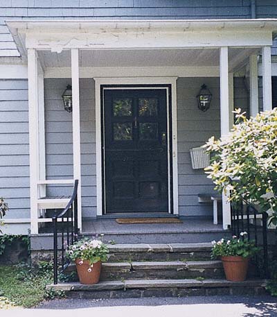flat-roofed entry porch built with undersized framing lumber 