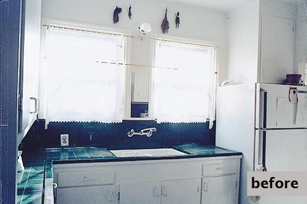 old kitchen had plain white tiles and was cramped