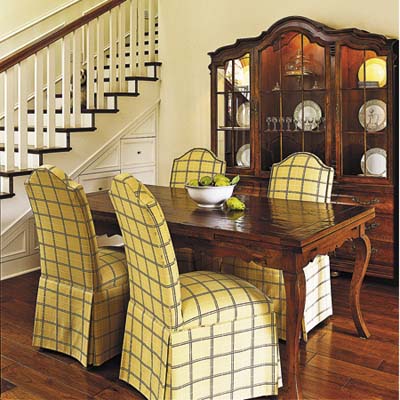 dining room has cabinets and drawers that open under the stairs