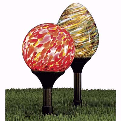 blown-glass orb lamps sit close to the ground