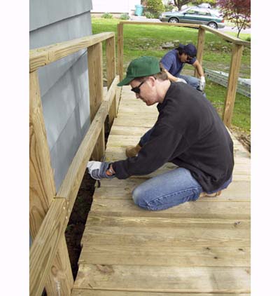 Timothy Dahl and John Taylor repair wheelchair ramp