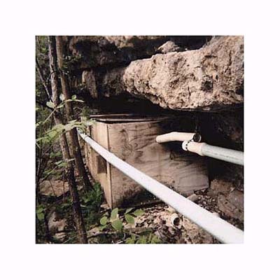 a plywood septic tank on the banks of a river