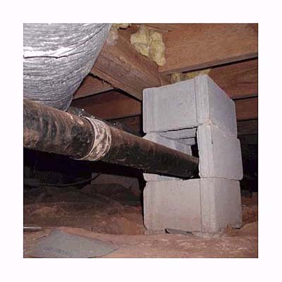 a concrete block pier that was field-modified by the plumber