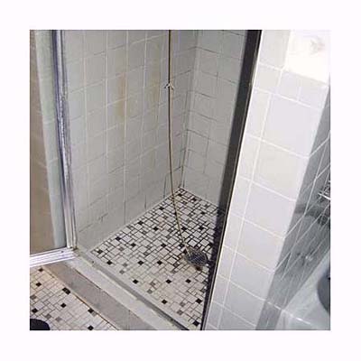 a string tied from the shower head to the drain to fix the drip
