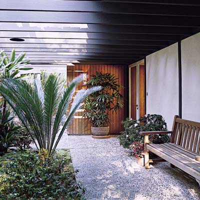 Windowed walkway with pocket doors and trelliswork overhead 