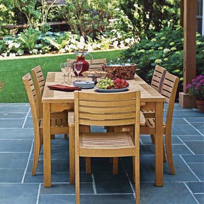 teak wood patio furniture on slate tile patio