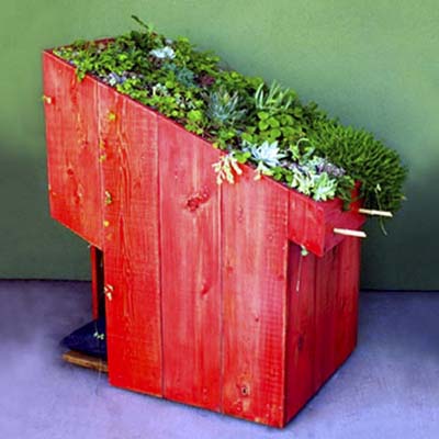 doghouse with a green roof on top