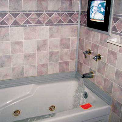 television set behind shower in bathtub