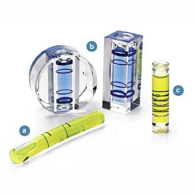 Vials made out of glass (a), bored-out blocks of solid acrylic (b), or injection-molded plastic (c)