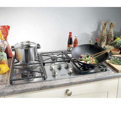 Miele stove top with a pot and wok