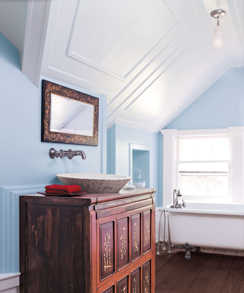panel molding adds old-house charm in attic bathroom with vanity furniture-type sink