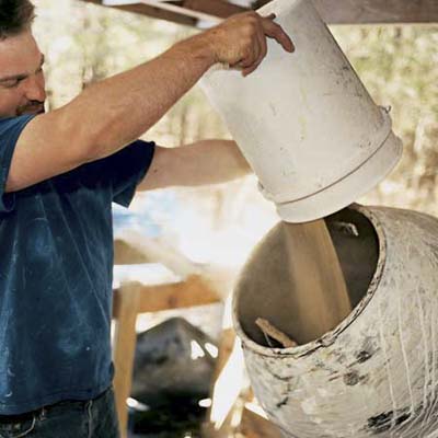man mixing sand in tumbler