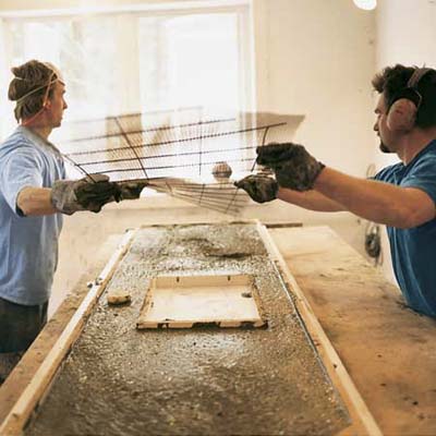 men smoothing the concrete mixture