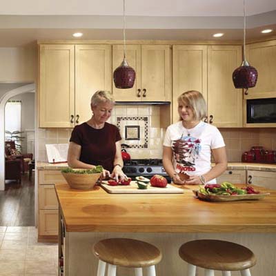 remodeled kitchen island with homeowner Anne Lyon and daughter Molly from a cottage remodel in Austin, TX