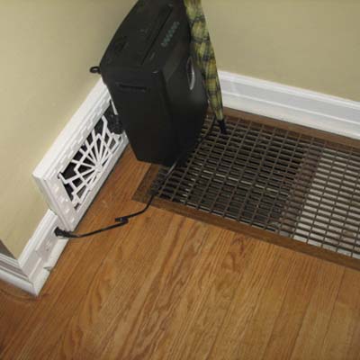an HVAC register placed right next to a cold air return on the floor
