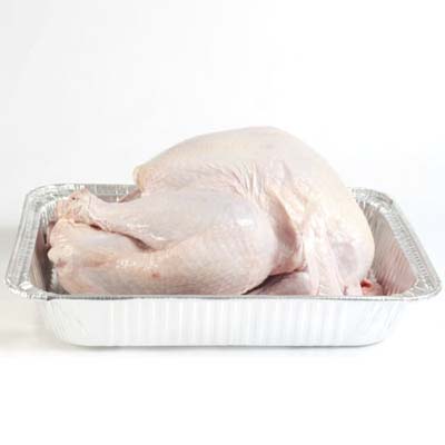 an uncooked chicken in a baking pan