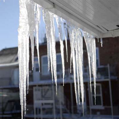 large icicles hanging under the eves of a house