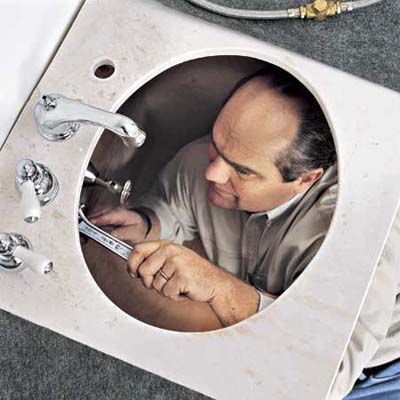 Richard Trethewey installing a sink at the Billerica TV Project from 1999