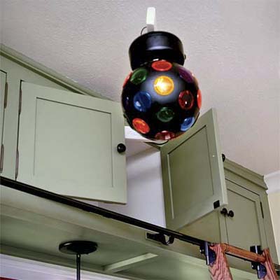 a strobe light hidden in an upper cabinet swings out so this vintage look kitchen can turn into a dance floor for entertaining guests