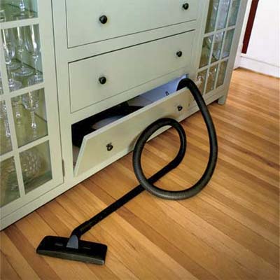 built in shop vac vacuum hidden in  a lower kitchen cabinet in this vintage look modern kitchen 