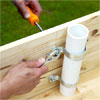 attaching the pipe strap assembly to the teeter-totter board