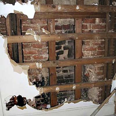the partially demolished wall showing the firebox concealed behind it