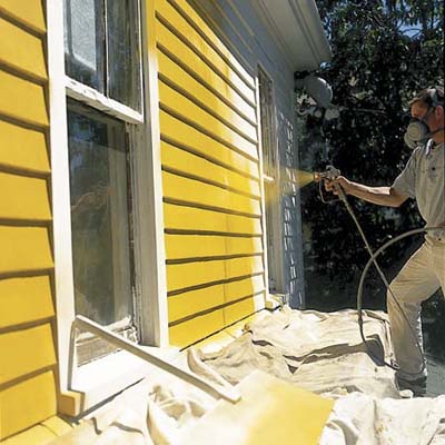 spray painting a home's exterior