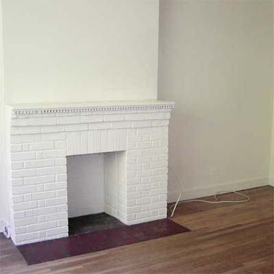 living room before, bare white walls, pine floors