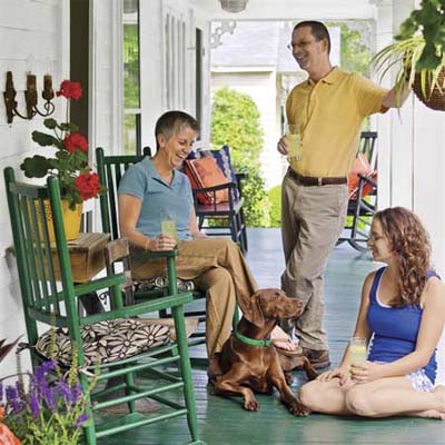 the homeowners on the porch of 1909 remodeled Craftsman