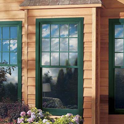 highly reflective glass and wood window seen from the outside of a house