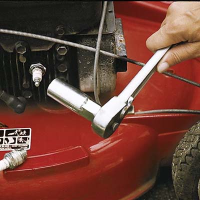 hand repairing lawn mower