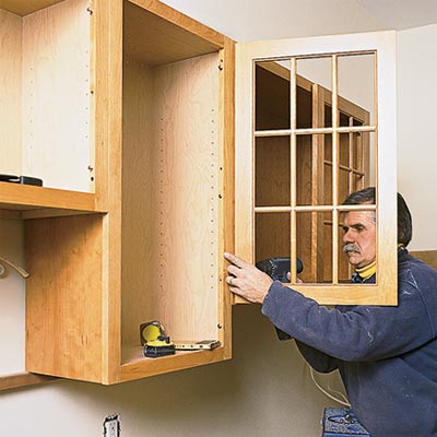 t o h contractor tom silva installing a kitchen cabinet